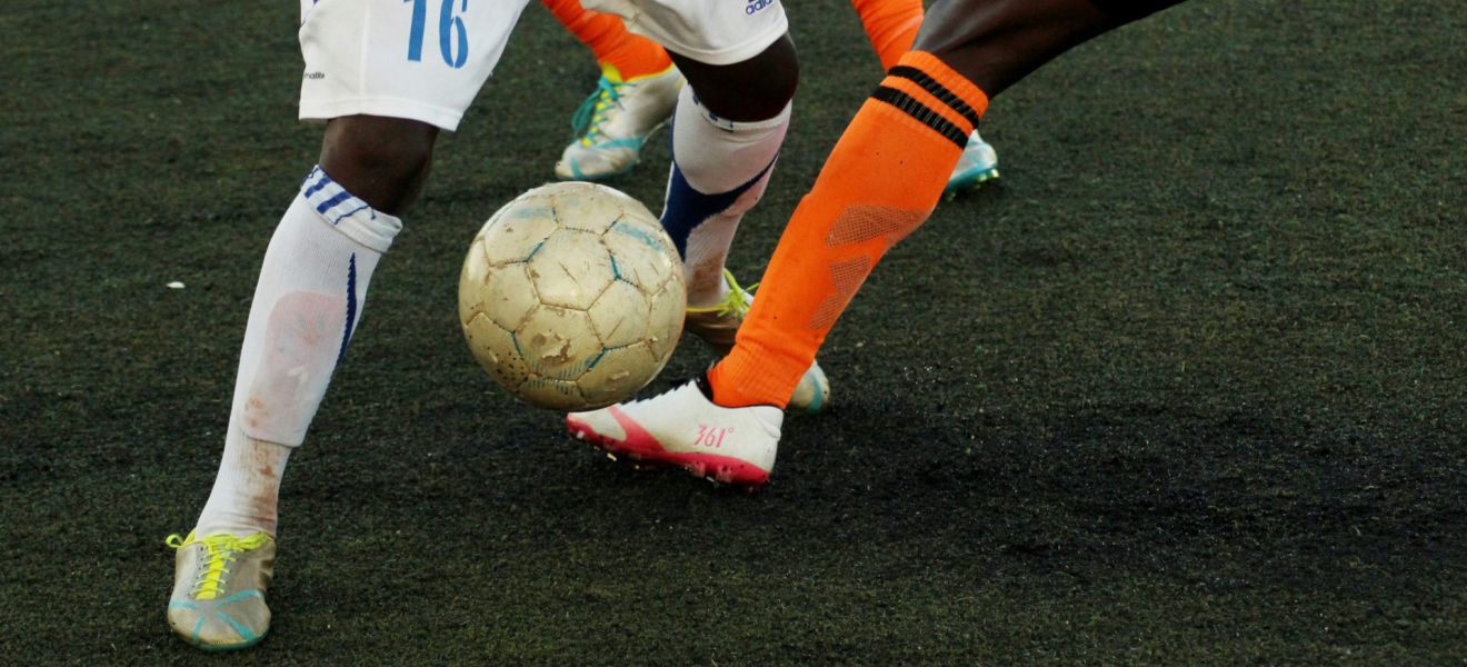 Close up of football be tackled from another player