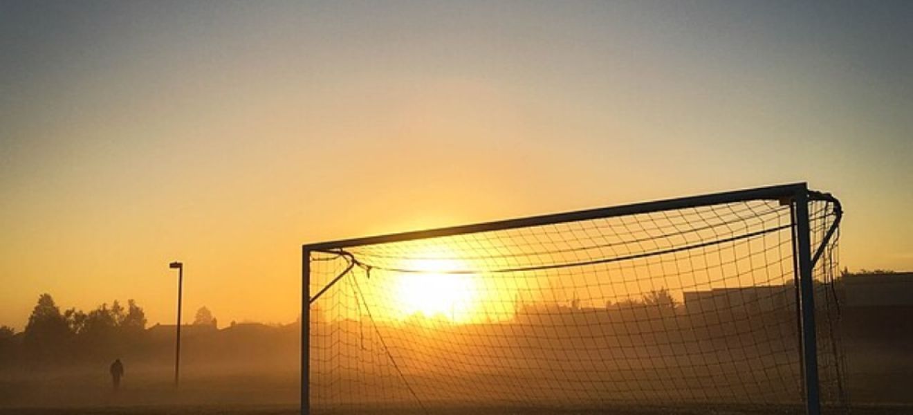 Football goal in the sunset 