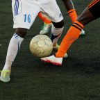 Close up of football be tackled from another player