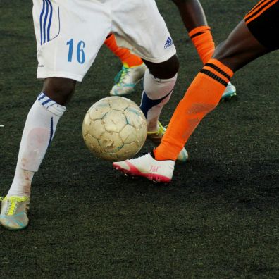 Close up of football be tackled from another player